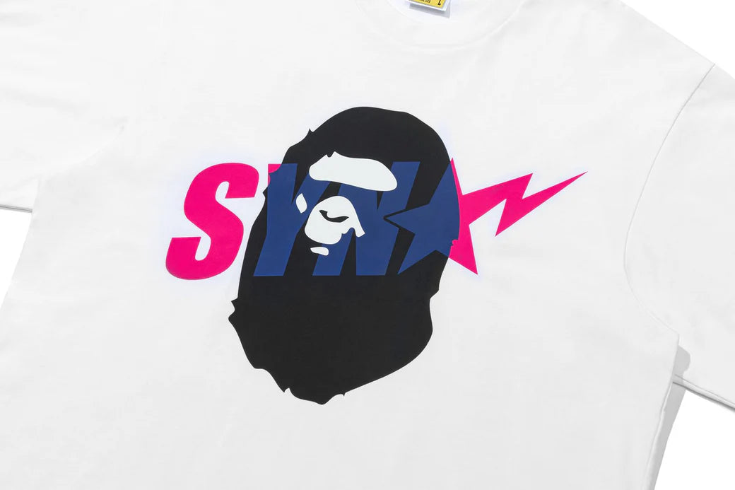 BAPE x Syna World graphic tee featuring a camouflage ape head logo