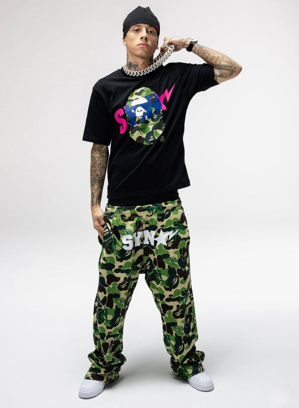 BAPE x Syna World graphic tee featuring a camouflage ape head logo