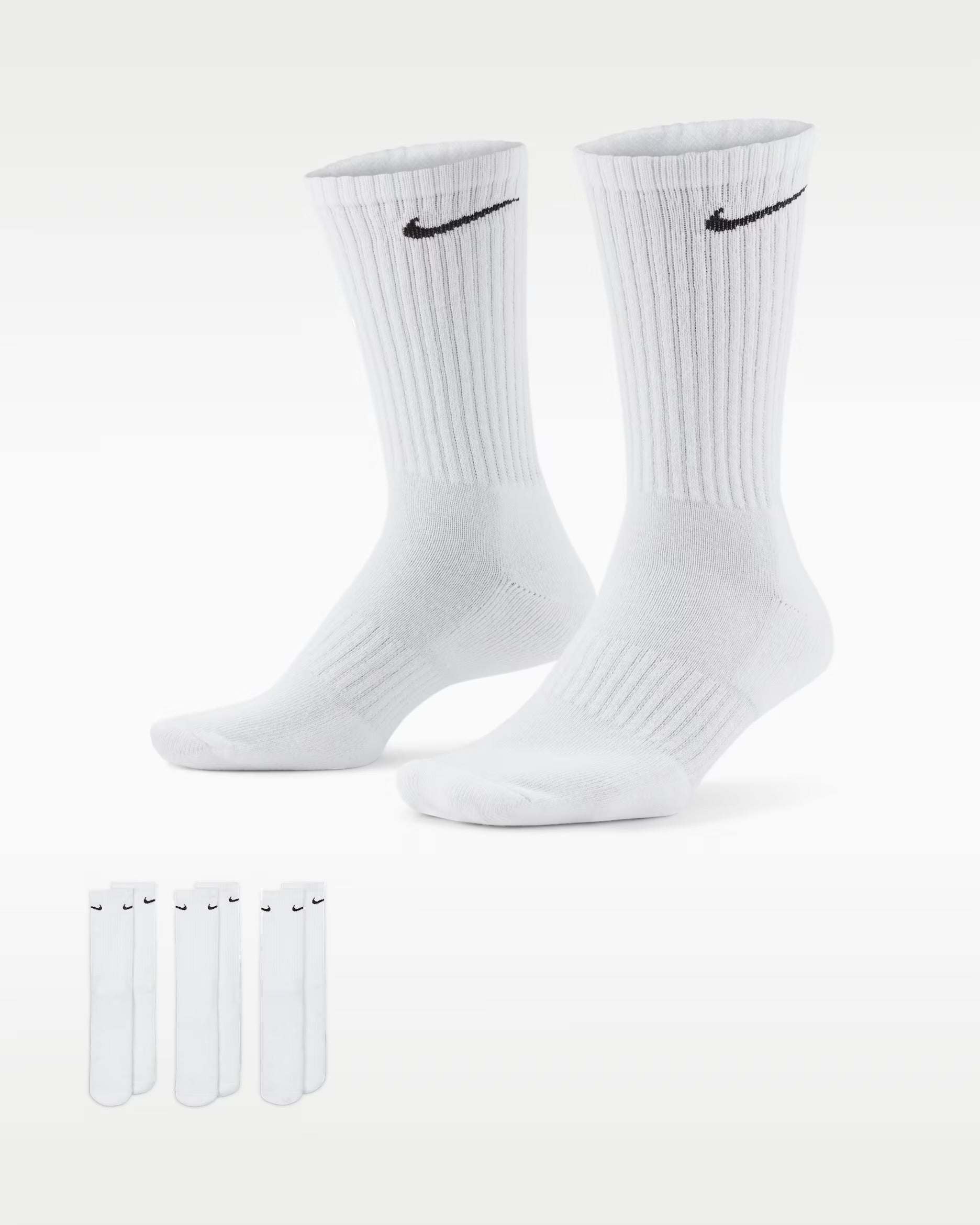 Two pairs of white socks with Nike logo on a white background